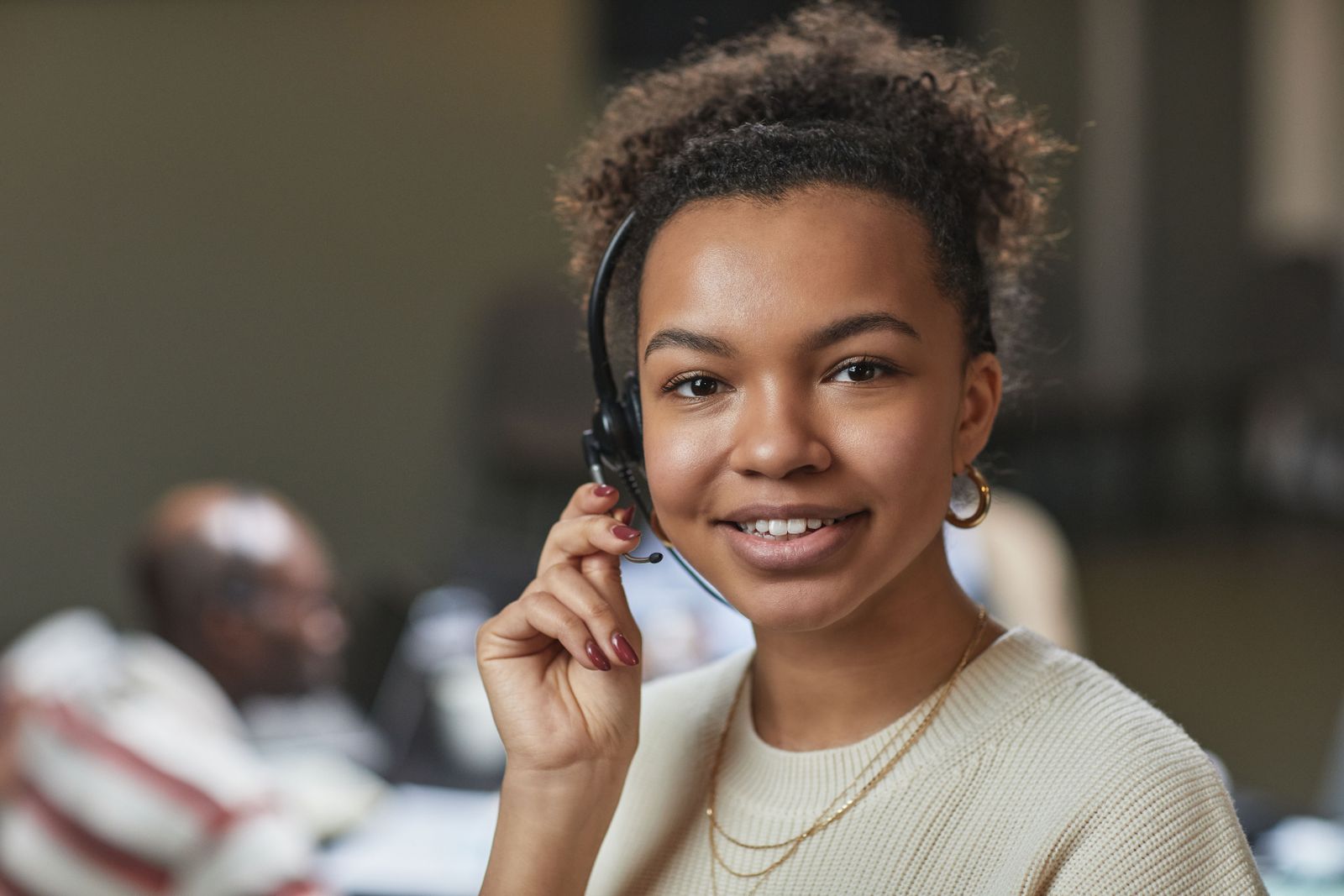 Smiling woman with headset on the phone